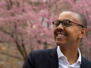 Gary Bennett with background of trees with pink flowers
