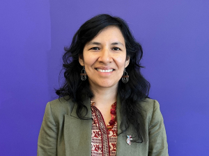 Angelica Serna Jeri standing against blue background